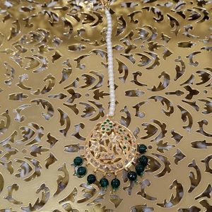 Elegant gold and green headpiece/tikka